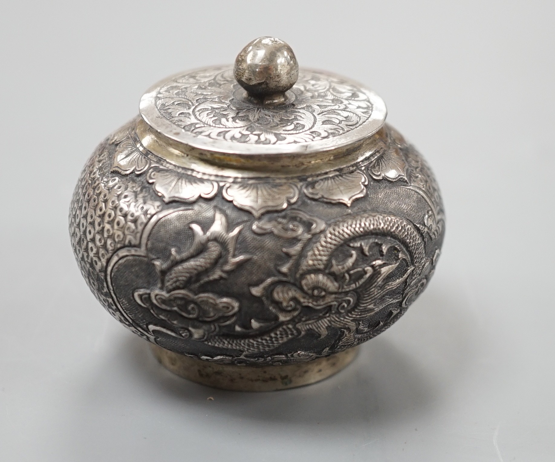A Chinese white metal unsigned pot and cover, 5cms high.